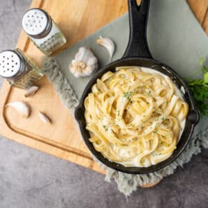 Alfredo pasta dinner with creamy white sauce and herbs
